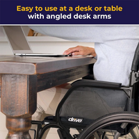 Person using a laptop at a desk with angled desk arms, featuring a wheelchair and 'Drive' brand.